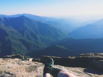 Low section of person relaxing on mountain