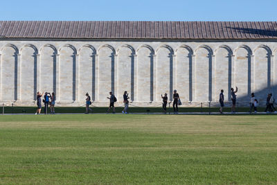 Group of people in front of built structure