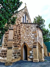 Low angle view of bell tower against sky