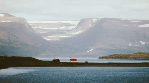 Scenic view of sea and mountains against sky