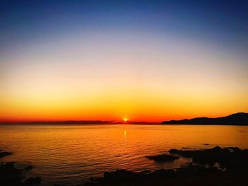 Scenic view of sea against romantic sky at sunset