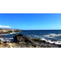 Scenic view of sea against clear blue sky