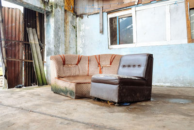 Empty chair in abandoned house