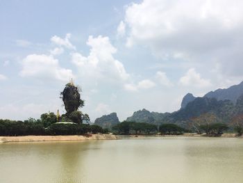 Scenic view of lake against cloudy sky