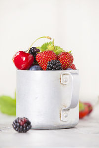 Close-up of strawberries on table against white background
