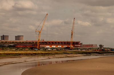 Construction site against cloudy sky