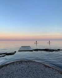 Scenic view of sea against clear sky during sunset