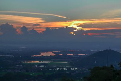 Aerial view of townscape against sky at sunset