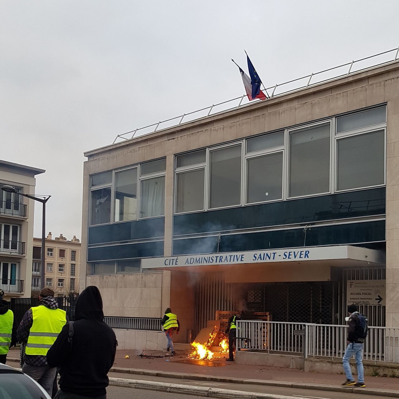 PEOPLE ON STREET AGAINST BUILDING