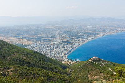 High angle view of sea and cityscape against sky