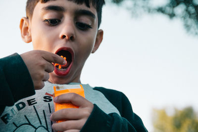 Portrait of boy eating candy