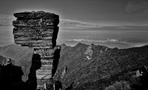 Panoramic view of rocks and mountain against sky