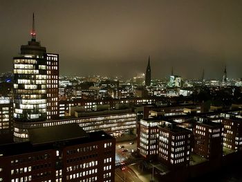 High angle view of city lit up at night