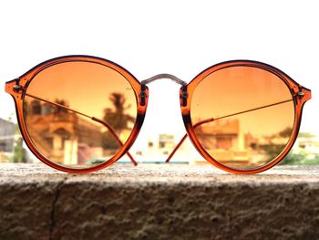 Close-up of sunglasses against sky