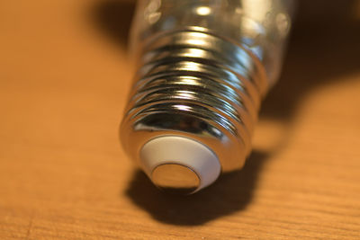 Close-up of light bulb on table