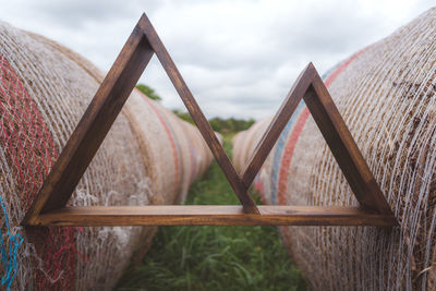 Close-up of rusty metal fence against sky