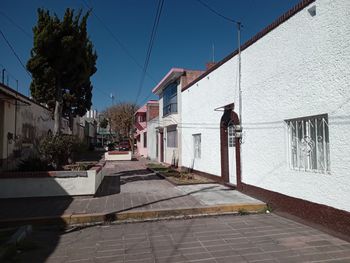 Street amidst buildings against sky