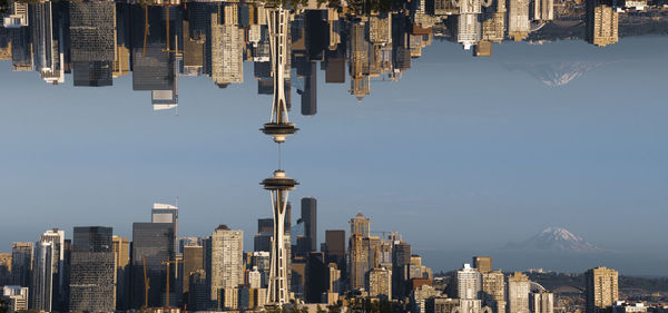 Panoramic view of buildings in city against sky