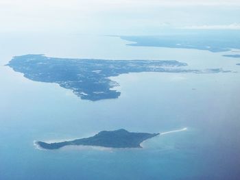 Aerial view of island amidst sea against sky