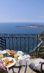 View of food on table by sea against sky