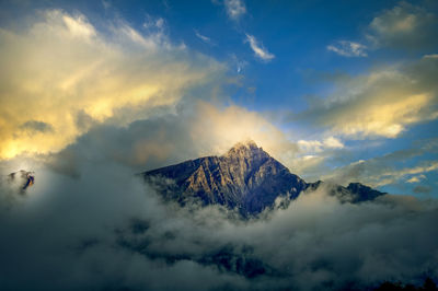 Scenic view of snowcapped mountains against sky during sunset