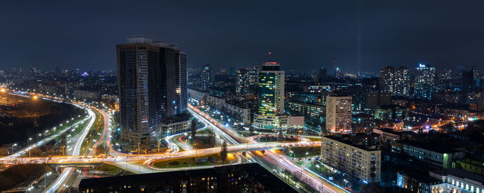 Illuminated cityscape against sky at night