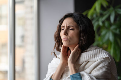 Unhealthy woman check glands has cold, fever and seasonal influenza suffer from painful sore throat