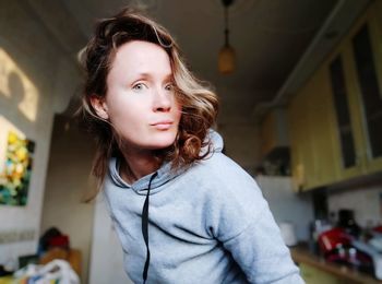 Portrait of beautiful woman standing at home