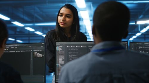 Side view of young woman standing in office