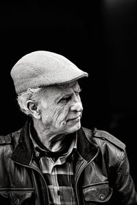 Portrait of man against black background