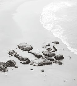 High angle view of rocks on sea shore during winter