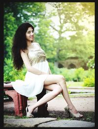 Portrait of young woman sitting outdoors