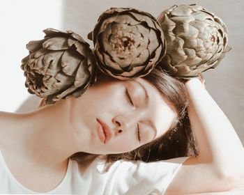 Close-up of beautiful woman with artichokes