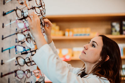 Female optometrist working at store