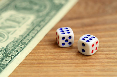 Close-up of dice and paper currency on table