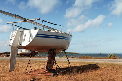 Traditional windmill on beach against sky