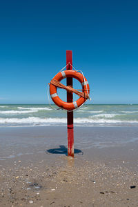 Lifeguard hut on beach against clear sky