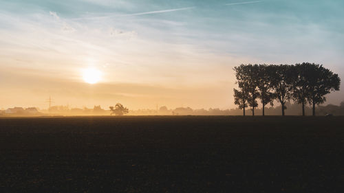 Scenic view of field against sky during sunset