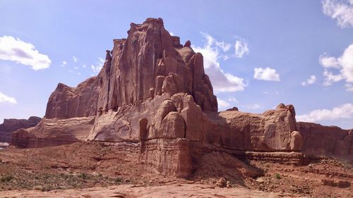 Low angle view of rock formations against sky