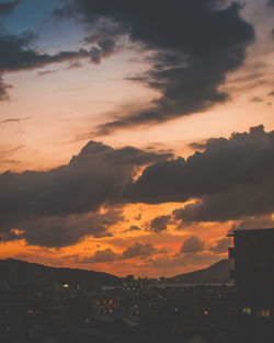 Silhouette buildings against sky during sunset