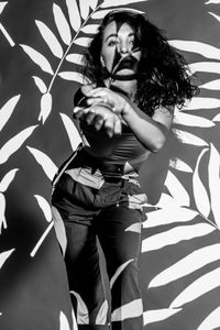 High angle view of woman standing against the wall