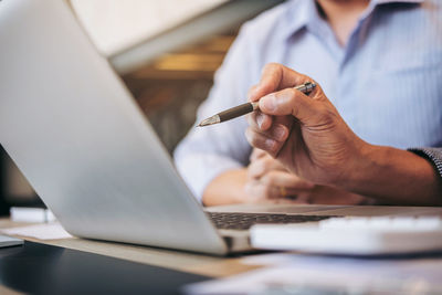 Close-up of business colleagues working in office