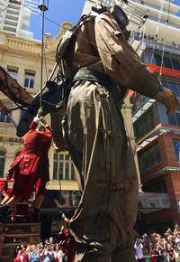 Low angle view of people in city