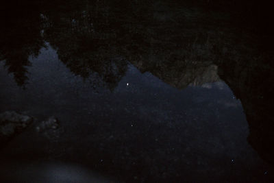 Reflection of sky in puddle on lake