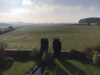 Scenic view of farm against sky