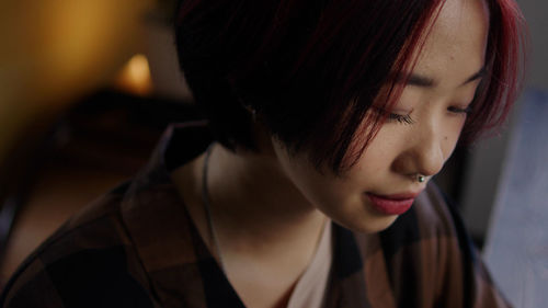 Close-up of young woman looking away