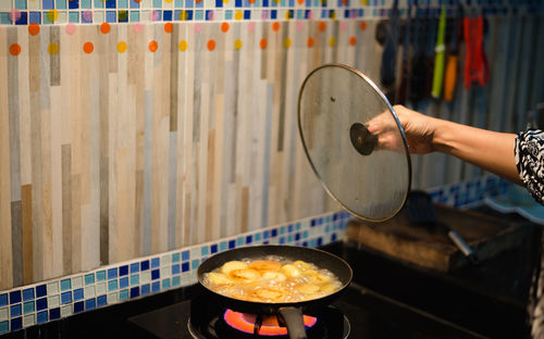 Cropped hand preparing food