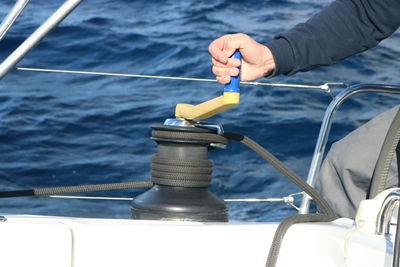 Close-up of hand holding lever in sailboat