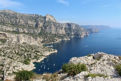 Scenic view of sea and mountains against sky