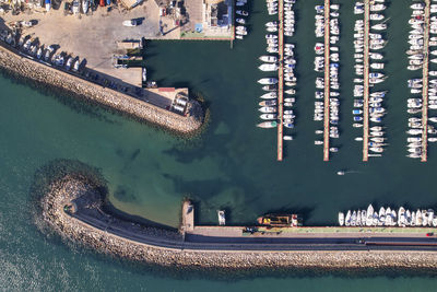 Top view of a small nautical port with several rows of small boats docked